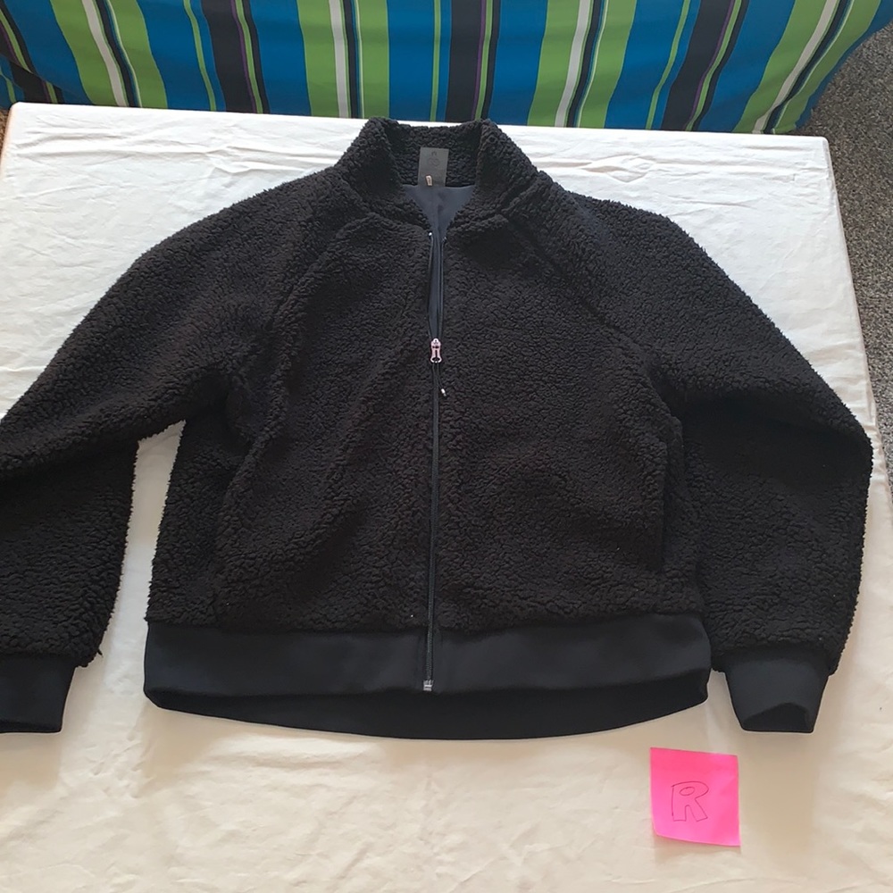 Black long-sleeved fuzzy coat.